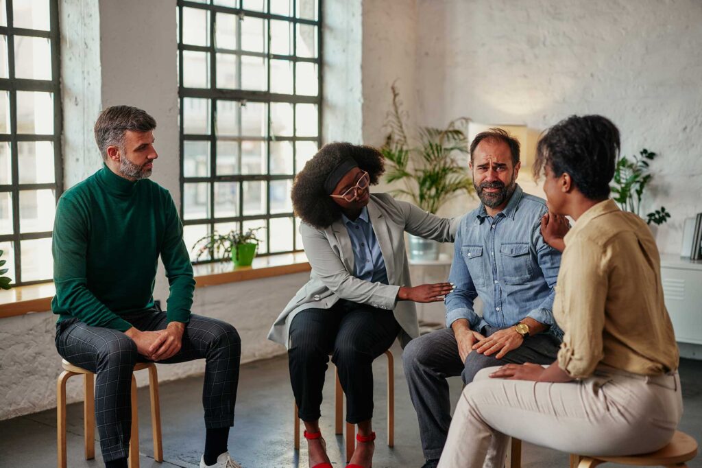 A therapist leads Group Therapy session.